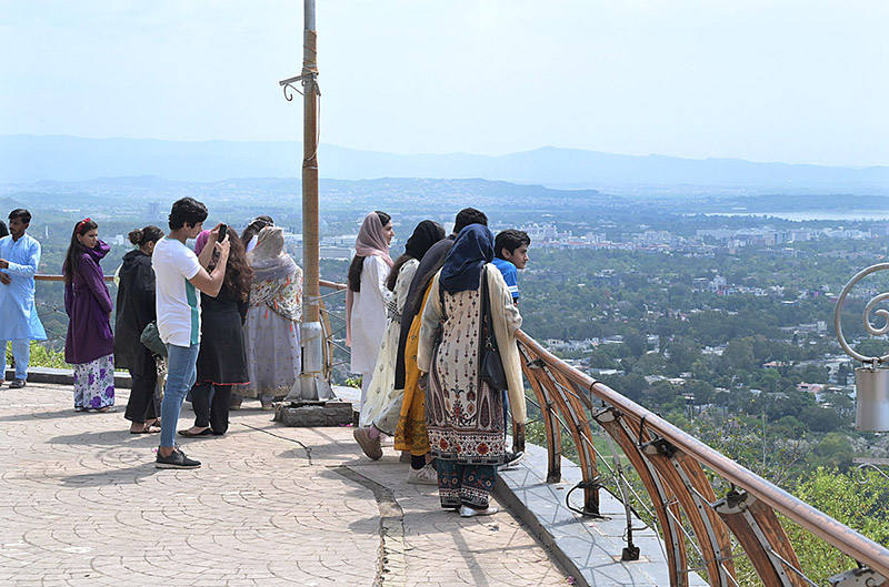 Foreigners enjoy bird eye view of the federal capital from the picnic point Daman e Koh.