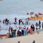 A large number of people visit the bank of River Indus