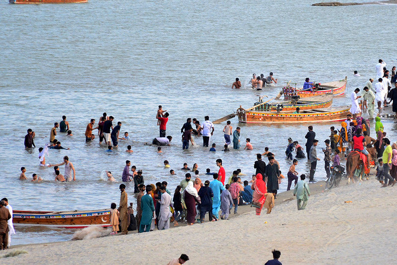 A large number of people visit the bank of River Indus