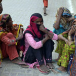 Beggar women sitting outside Faizan-e-Madina Masjid during Jummatul Wida (last Friday) prayer of Holy Fasting Month of Ramzanul Mubarak