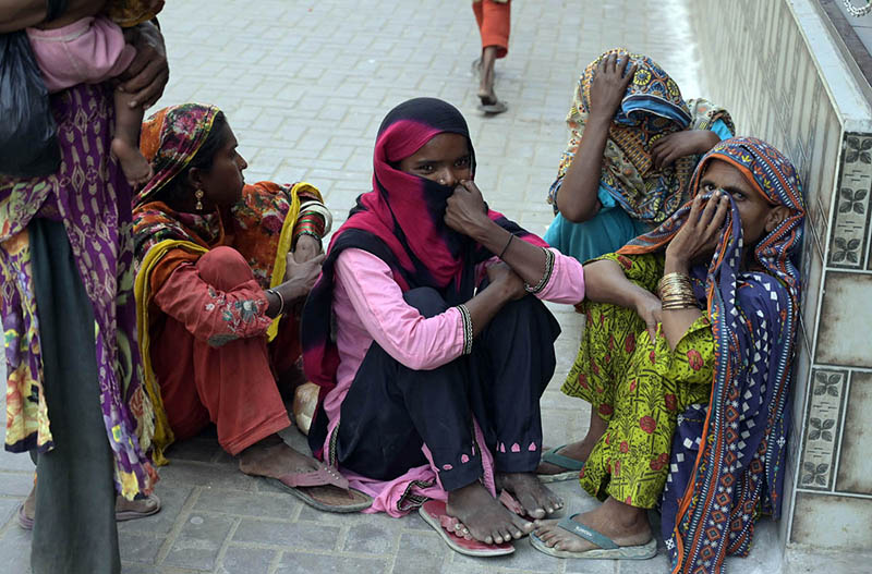 Beggar women sitting outside Faizan-e-Madina Masjid during Jummatul Wida (last Friday) prayer of Holy Fasting Month of Ramzanul Mubarak