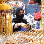women selecting Artificial jewelry in connection with preparations for Eid-ul-Fitr