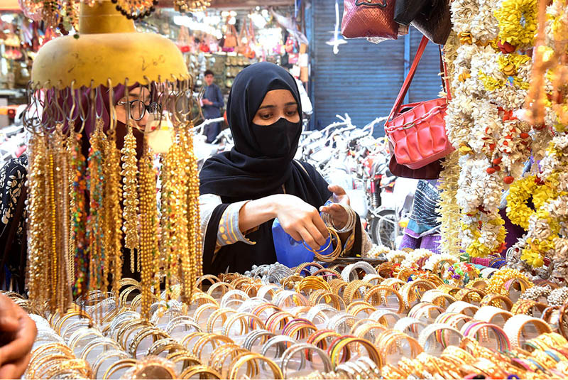 women selecting Artificial jewelry in connection with preparations for Eid-ul-Fitr