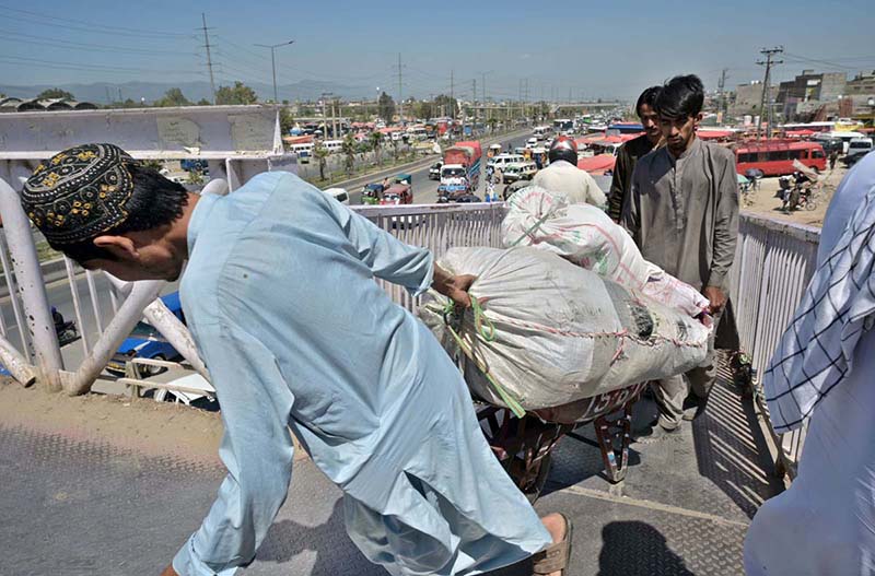People purchasing tickets and waiting for transport to travel their hometowns to celebrate Eid ul Fitr with their loved ones at Faizabad Bus Stand.