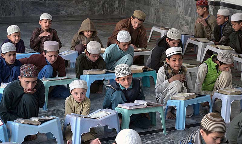 Madrassa students reciting holy Quran during fasting month of Ramadan at Jamia Anwaar ul Aloom near Banni chowk.