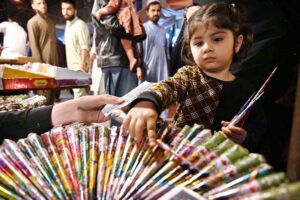 A child selecting mehndi in connection with upcoming Eid ul Fitr shopping at Shafi Market.