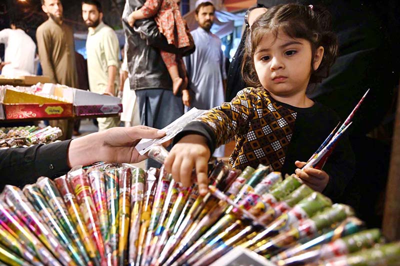 A child selecting mehndi in connection with upcoming Eid ul Fitr shopping at Shafi Market.