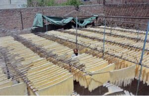 Worker busy in hanging the vermicelli for dry purpose at his workplace in connection with upcoming Eidul Fitr.