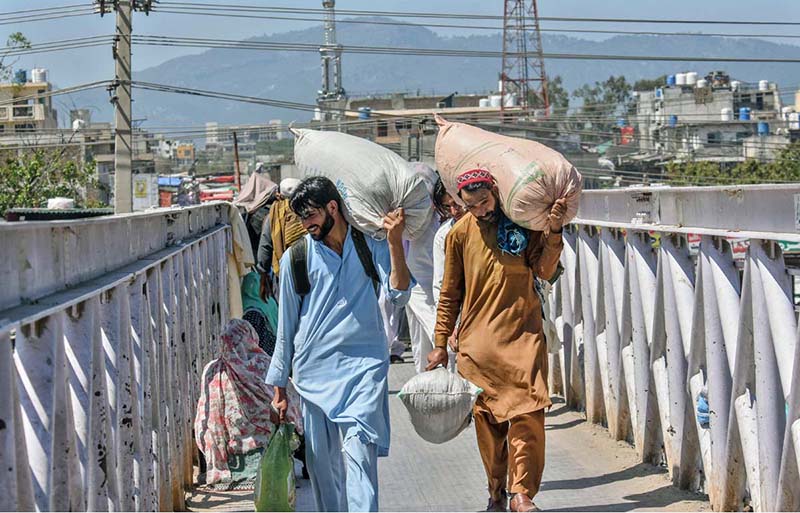 People purchasing tickets and waiting for transport to travel their hometowns to celebrate Eid ul Fitr with their loved ones at Faizabad Bus Stand.