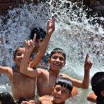 Youngsters are enjoying bathing in tube well to get relief from hot weather in the city