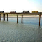 A view of heavy vehicles passing through the bridge on the Indus River at the Bypass area