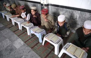 Madrassa students reciting holy Quran during fasting month of Ramadan at Jamia Anwaar ul Aloom near Banni chowk.