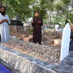 People offering Fateha on the graves of their family members in graveyard on the occasion of Eidul Fitr