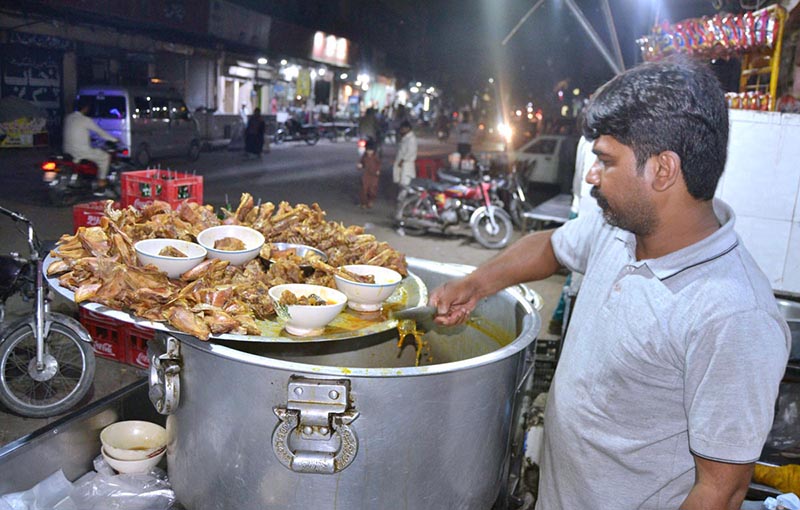 vendor selling traditional food stuff to customers for sehri at Anarkali Bazaar during Holy Fasting Month of Ramzan ul Mubarak.