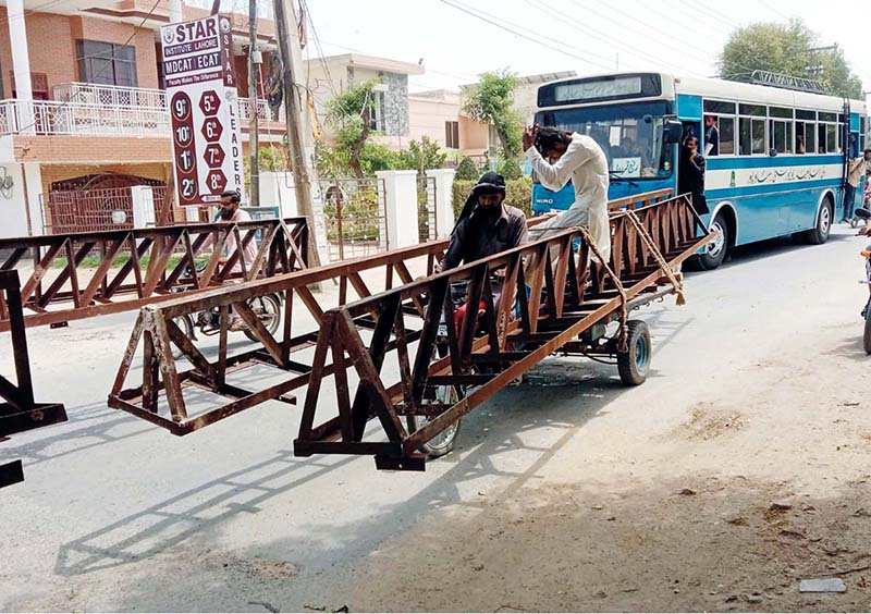 Motorcycle rickshaw loaded with iron poles may cause any accident and needs attention of concerned authorities