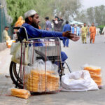 A disabled person selling food item for livelihood at a local park