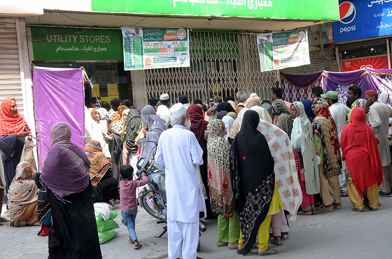 Women in a queue to get flour bags on the subsidize rate at a utility store