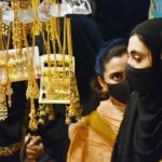 Women selecting and purchasing artificial jewelry from vendor in preparation of upcoming Eidul Fitr