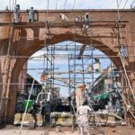 Labourers busy in renovation work of historic Qissa Khawani Bazaar Gate.
