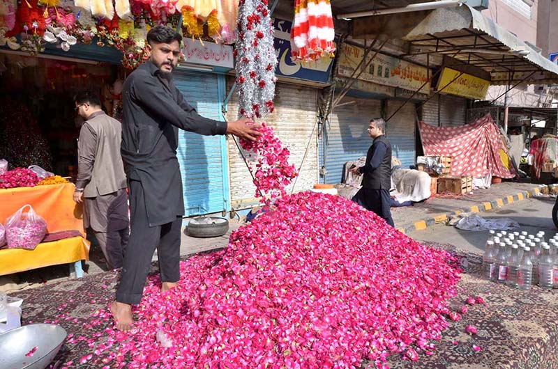 A vendor displaying flowers at temporary stall near I-9 graveyard as a large number of people visit graveyards on Eidul Fitr to offer Fateha on graves of their family members.