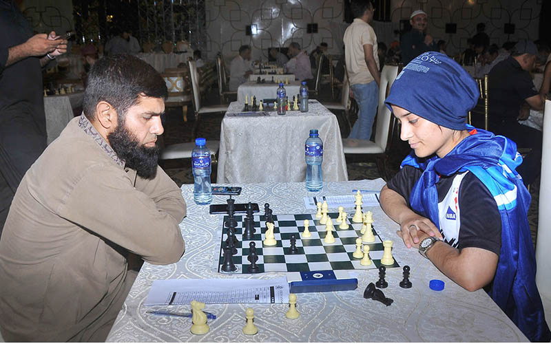 Chess players participating in chess competitions during the first South Punjab chess tournament at the Railway Club organized by the Chess Association of Punjab