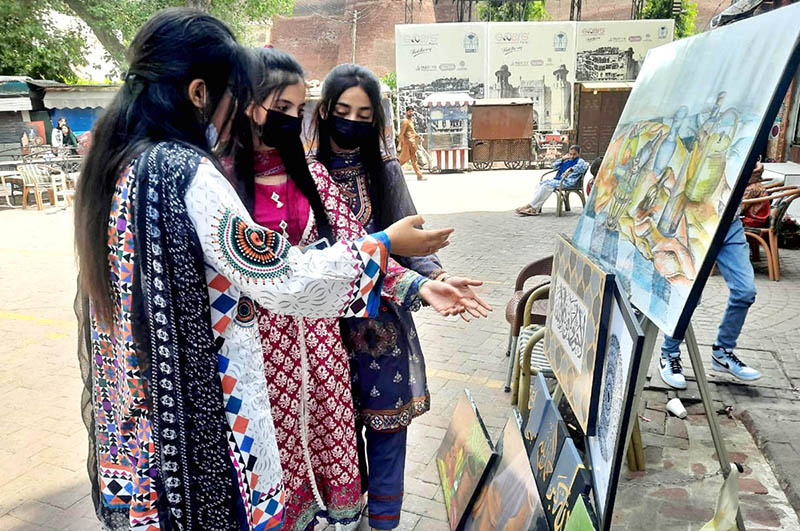 Visitors keenly viewing Painting & Calligraphy Exhibition organized by the The Formanite School System in collaboration with Walled City of Lahore Authority