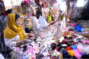 A vendor displaying artificial jewelry to attract customers at G-9 Markaz