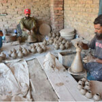 Workers busy in preparing the clay made pots at his workplace