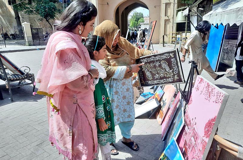 Visitors keenly viewing Painting & Calligraphy Exhibition organized by the The Formanite School System in collaboration with Walled City of Lahore Authority