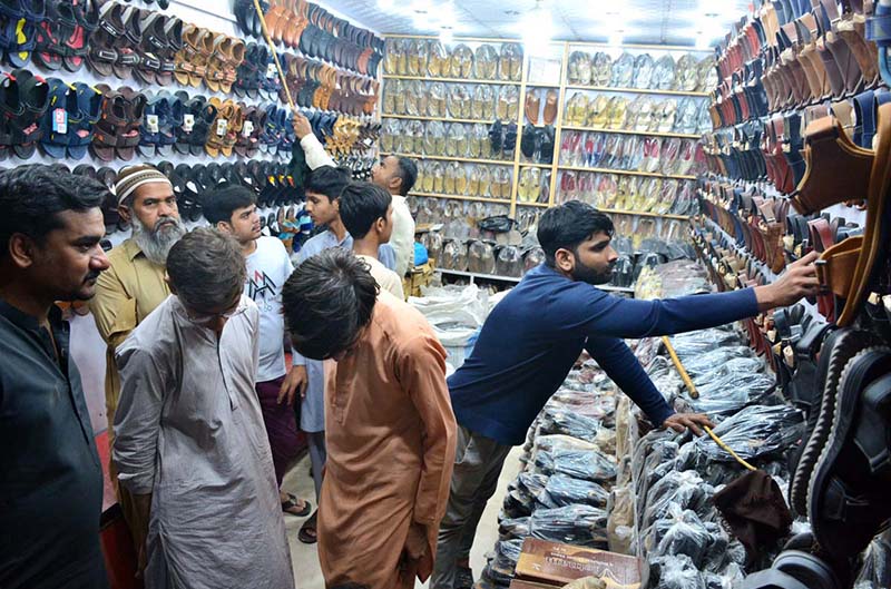 Women selecting and purchasing artificial jewelry from vendor in preparation of upcoming Eidul Fitr
