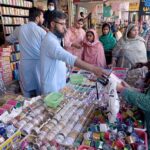 A vendor displaying artificial jewelry to attract customers at G-9 Markaz