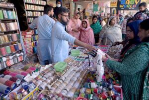 A vendor displaying artificial jewelry to attract customers at G-9 Markaz