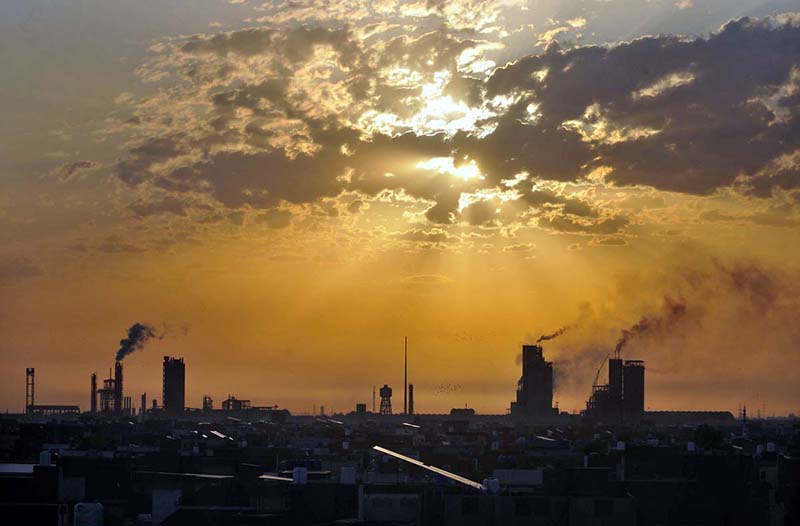 A beautiful view of sunrays peeping through clouds during sunrise over the sky.