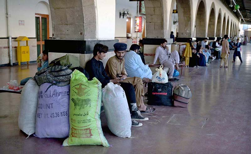 Laborer carrying passenger’s luggage on loader to load on train at Railway Station