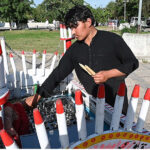 A vendor selling a traditional ice lolly (Qulfi) to attract customers outside Faisal Masjid
