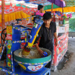 Vendor is busy preparing a traditional summer drink (Sardai) for customers at his roadside setup