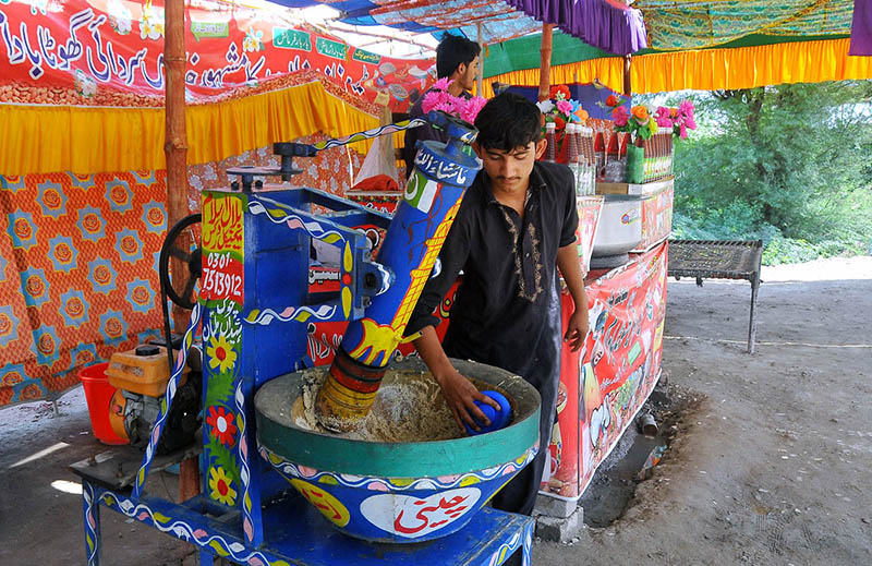 Vendor is busy preparing a traditional summer drink (Sardai) for customers at his roadside setup