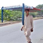 A person on the way carrying traditional bed (Charpai) on his head