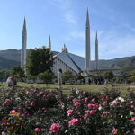 An attractive view of the famous Faisal Masjid with a with beautiful flowers blooming to mark spring season