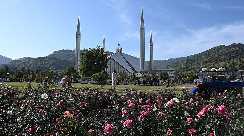 An attractive view of the famous Faisal Masjid with a with beautiful flowers blooming to mark spring season