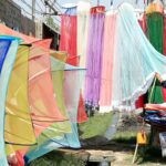 A vendor displaying mosquito protective nets to attract the customers at Charsadda road