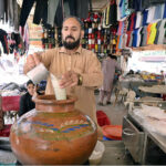 A vendor displaying traditional drink (lassi) to attract the customers during hot day in the city.