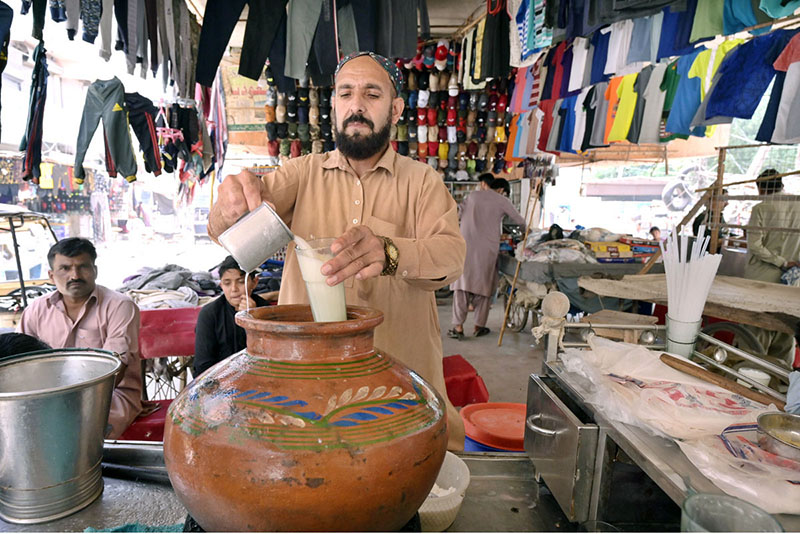 A vendor displaying traditional drink (lassi) to attract the customers during hot day in the city.
