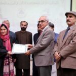 VC Karakoram International University Attaullah Shah giving away certificate to the participant during the Husn-e-Qiraat and Natia competition at KIU