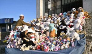 A vendor displaying toys to attract customers at Faizabad.