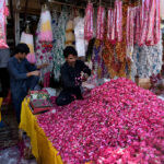 A vendor displaying garlands to attract customers at at Bani Chowk