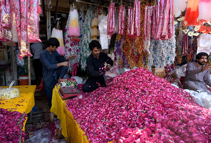 A vendor displaying garlands to attract customers at at Bani Chowk