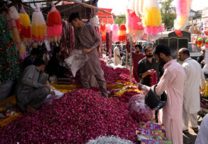 A vendor displaying garlands to attract customers at at Bani Chowk