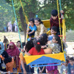 Children enjoy swings in Gulshan-e-Iqbal Park on the 2nd day of Eid-ul-Fitr celebrations