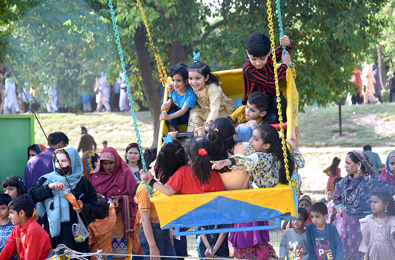 Children enjoy swings in Gulshan-e-Iqbal Park on the 2nd day of Eid-ul-Fitr celebrations
